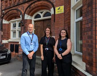 St Leger staff in front of building