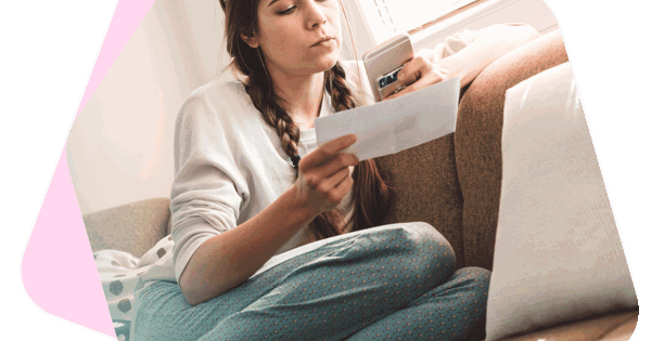 Woman holding phone and paperwork