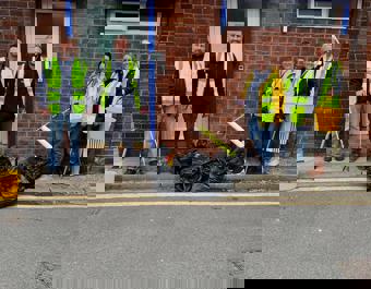 St Leger staff posing for photograph with litter pickers