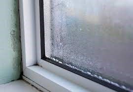 A photo of the corner of a window with condensation build up