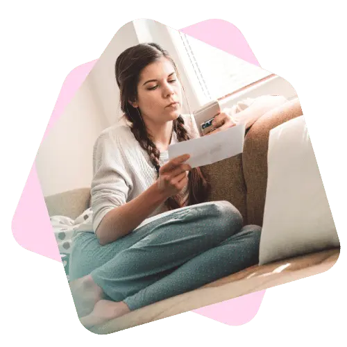 Woman holding phone and paperwork