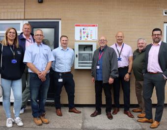 St Leger staff in front of fire safety box